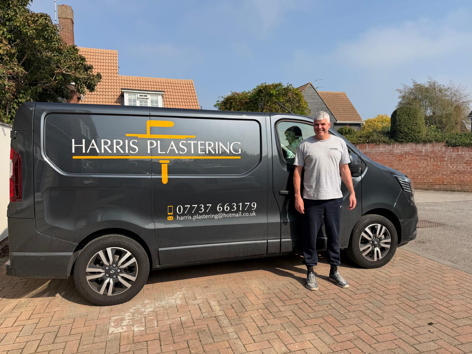 Harris Plastering tradesman beside the Harris Plastering work van